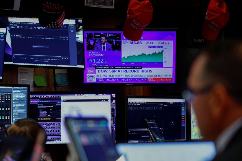 A screen displays stock market index data as traders work on the floor at the New York Stock Exchange (NYSE) in New York City, U.S., August 4, 2026. REUTERS/Jeenah Moon