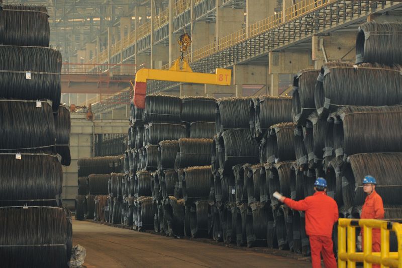 FILE PHOTO: Employees work next to steel wires at a Dongbei Special Steel plant in Dalian, Liaoning province, China November 2, 2018. Picture taken November 2, 2018. REUTERS/Stringer/File Photo