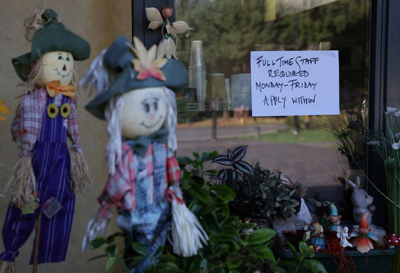 A job advertisement for help wanted is posted in the window of The Garden Cafe in Eastcote, Britain, July 20, 2023. REUTERS/Suzanne Plunkett