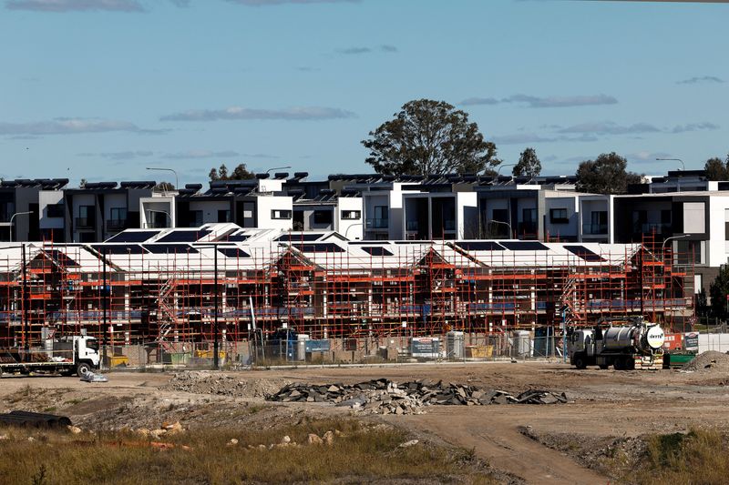 Houses under construction stand in front of newly built homes at a housing development in the south-west Sydney, Australia, August 4, 2026.  REUTERS/Izhar Khan