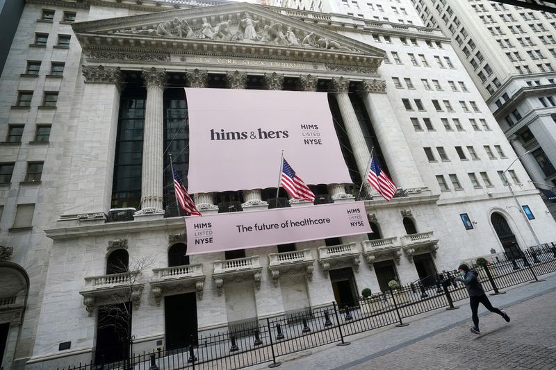 FILE PHOTO: FILE PHOTO: The New York Stock Exchange with a Hims & Hers Health, Inc banner is pictured as a person runs past in the Manhattan borough of New York City, New York, U.S., January  21, 2021. REUTERS/Carlo Allegri/File Photo/File Photo