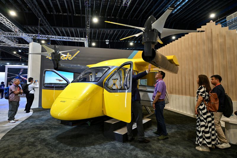 FILE PHOTO: Attendees inspect a Wisk aircraft by the Boeing pavilion, at the Singapore Airshow at Changi Exhibition Centre, in Singapore, February 3, 2026. REUTERS/Caroline Chia/File Photo