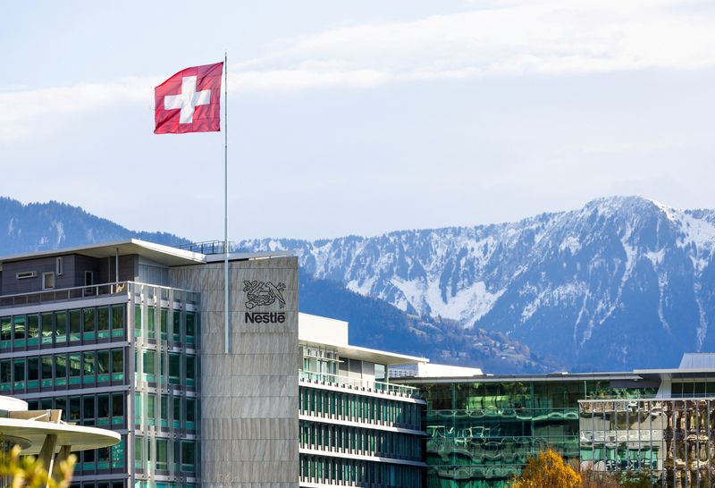 FILE PHOTO: A Swiss flag flutters on the headquarters of Nestle in Vevey, Switzerland, November 25, 2024. REUTERS/Denis Balibouse/File Photo
