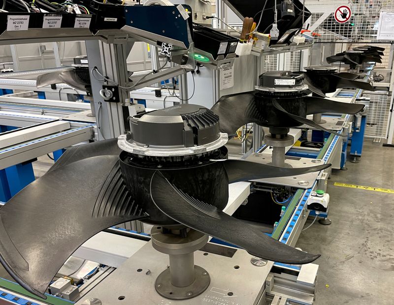 FILE PHOTO: Fans sit on the assembly line of the ebm-papst Group, a manufacturer of electric motors and fans in Mulfingen, Germany, July 19, 2022.     REUTERS/Frank Simon/ File Photo