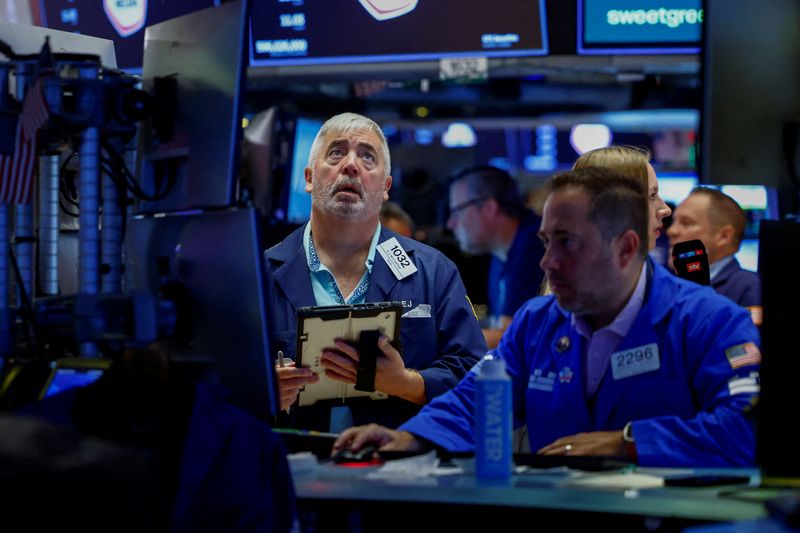 FILE PHOTO: Traders work on the floor of the New York Stock Exchange (NYSE) in New York City, U.S., August 7, 2026. REUTERS/Jeenah Moon/File Photo
