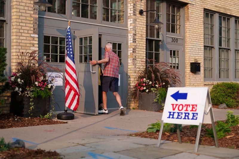 FILE PHOTO: People make their way into an voting site on primary election day in Minneapolis, Minnesota, U.S., August 11, 2026. REUTERS/Tim Evans/File Photo
