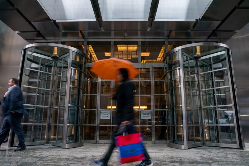 FILE PHOTO: A person walks by the Signature Bank headquarters, in New York City, U.S., March 13, 2023. REUTERS/David 'Dee' Delgado/ File Photo