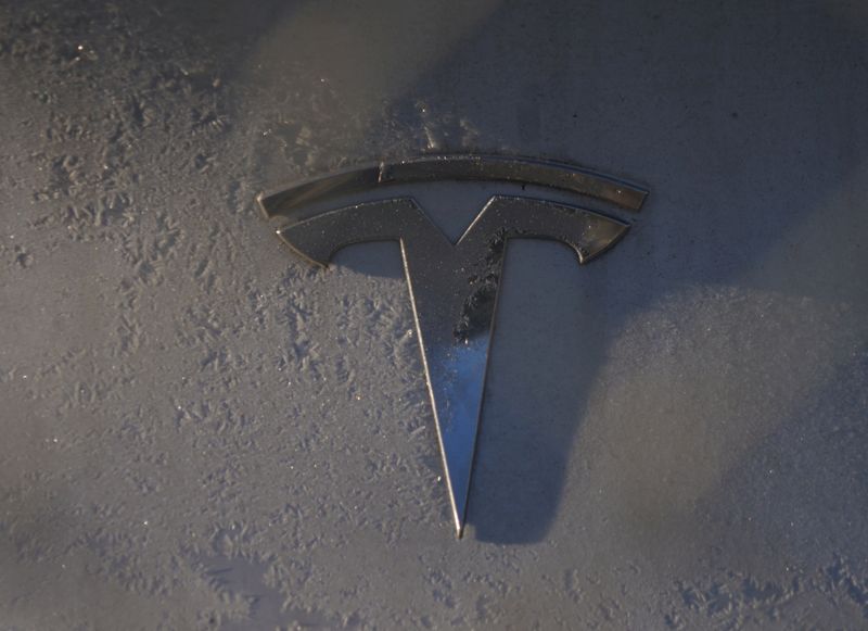 A Tesla sign is displayed on a car outside a showroom for the company in Malmo, Sweden, December 14, 2023. REUTERS/Tom Little/File Photo