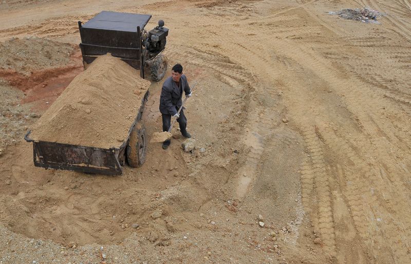 FILE PHOTO: A  labourer works at a site of a rare earth metals mine at Nancheng county, Jiangxi province March 14, 2012. REUTERS/Stringer/File Photo