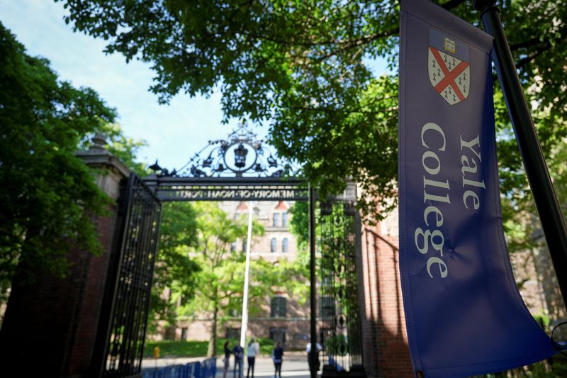 A Yale College banner hangs on the campus of Yale University on Commencement Day, in New Haven, Connecticut, U.S. May 19, 2025.  REUTERS/Bryan Woolston/File Photo