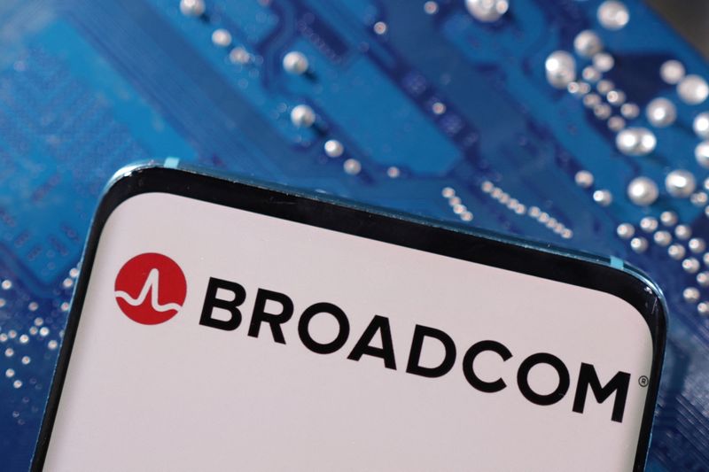 A smartphone with a displayed Broadcom logo is placed on a computer motherboard in this illustration taken March 6, 2023. REUTERS/Dado Ruvic/Illustration/File Photo