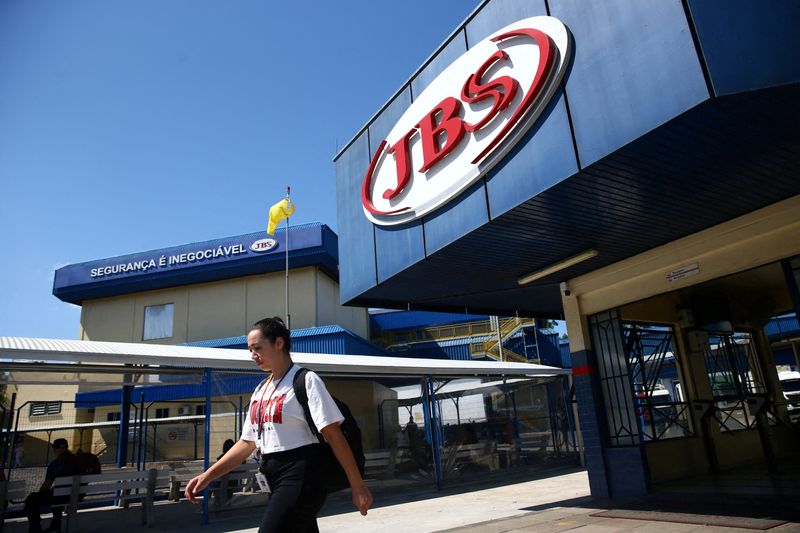 FILE PHOTO: A woman walks in front of the JBS meat factory, in Montenegro, Rio Grande do Sul, Brazil, December 5, 2024. REUTERS/Diego Vara/File Photo