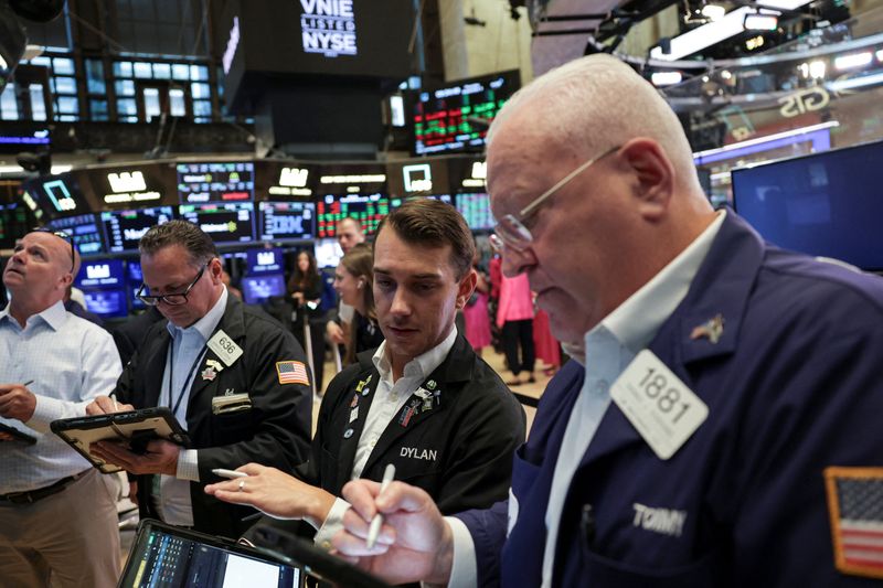 FILE PHOTO: Traders work on the floor at the New York Stock Exchange (NYSE) in New York City, U.S., September 4, 2025. REUTERS/Jeenah Moon/File Photo