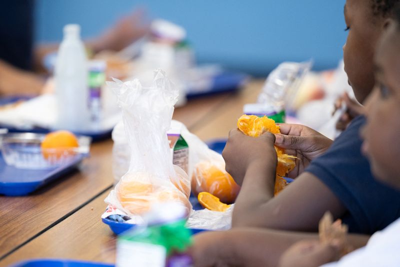 FILE PHOTO: A student eats a local orange for lunch in Tucson, Arizona, U.S., April 29, 2025. REUTERS/Caitlin O'Hara/File Photo