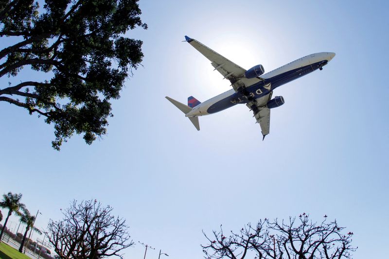 FILE PHOTO: A Delta Airlines passenger jet approaches to land at LAX in Los Angeles, California, U.S., April 7, 2021. REUTERS/Mike Blake/File Photo