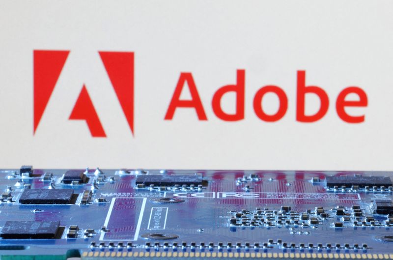 FILE PHOTO: Adobe logo is seen near computer motherboard in this illustration taken January 8, 2024. REUTERS/Dado Ruvic/Illustration/File Photo