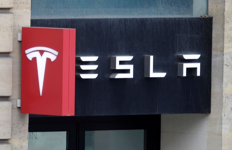 The logo of Tesla is seen on a store in Paris, France, October 30, 2020. REUTERS/Charles Platiau/File Photo
