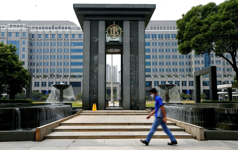 FILE PHOTO: A man walks past Bank Indonesia headquarters in Jakarta, Indonesia, September 2, 2020. REUTERS/Ajeng Dinar Ulfiana/File Photo