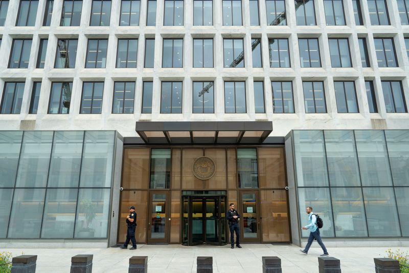 A person walks past the main entrance to the Federal Reserve Board Building, during the Federal Open Market Committee meeting on interest rate policy at the Federal Reserve, in Washington, D.C., U.S., September 17, 2025. REUTERS/Ken Cedeno
