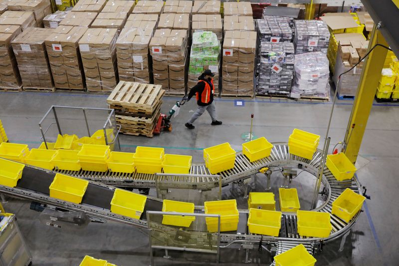 FILE PHOTO: Amazon workers perform their jobs inside of an Amazon fulfillment center on Cyber Monday in Robbinsville, New Jersey, U.S., December 2, 2019.  REUTERS/Lucas Jackson/File Photo