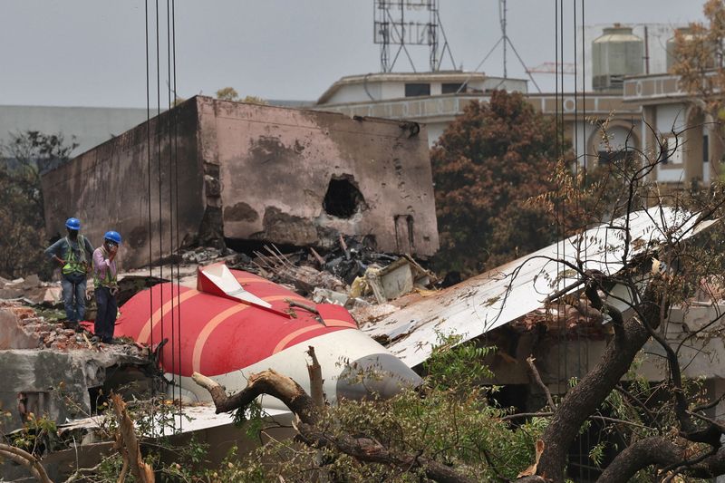 FILE PHOTO: Members of Indian Army's engineering arm prepare to remove the wreckage of an Air India aircraft, bound for London's Gatwick Airport, which crashed during take-off from an airport in Ahmedabad, India June 14, 2025. REUTERS/Amit Dave/File Photo