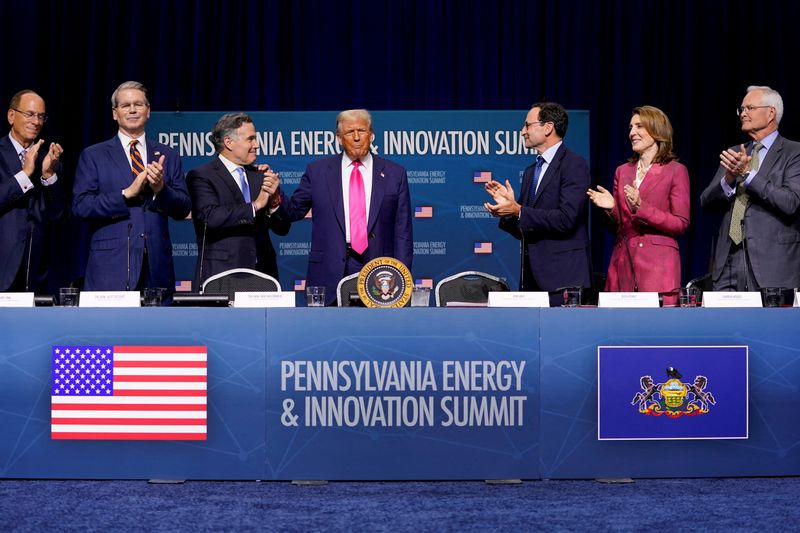 Chairman and CEO of BlackRock Larry Fink, U.S. Treasury Secretary Scott Bessent, Senator Dave McCormick (R-PA), Chief Operating Officer of Blackstone Jon Gray, Alphabet & Google President and Chief Investment Officer Ruth Porat and CEO of Exxon Mobil Corporation Darren Woods applaud as U.S. President Donald Trump arrives to attend the Pennsylvania Energy and Innovation Summit, at Carnegie Mellon University in Pittsburgh, Pennsylvania, U.S., July 15, 2025. REUTERS/Nathan Howard/ File Photo