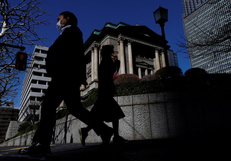 FILE PHOTO: Pedestrians walk past the Bank of Japan building in Tokyo, Japan March 18, 2024. REUTERS/Kim Kyung-Hoon/File Photo