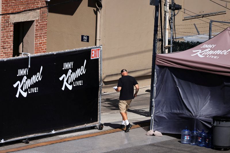 A person walks towards the theatre where "Jimmy Kimmel Live!" was recorded for broadcast following announcement by Disney that "Jimmy Kimmel Live" will return to its ABC network lineup on Tuesday, in Los Angeles, California, U.S. September 22, 2025. REUTERS/David Swanson