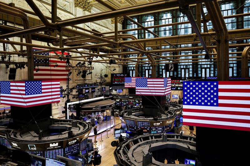 FILE PHOTO: American flags are displayed on screens on the floor at the New York Stock Exchange (NYSE) in New York City, U.S., September 22, 2025. REUTERS/Jeenah Moon/File Photo