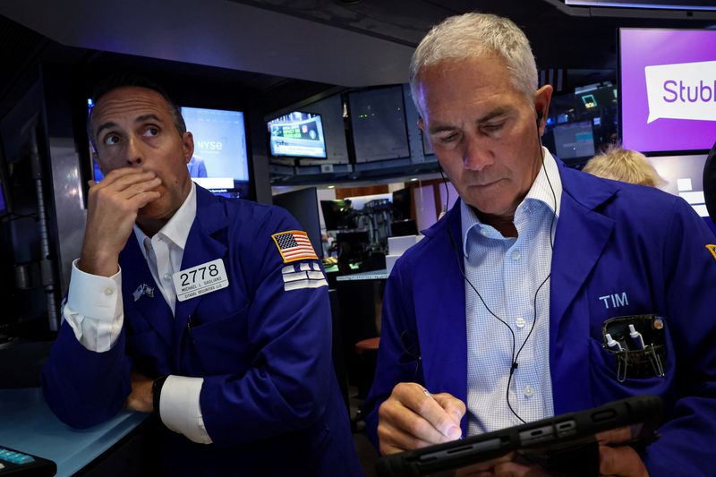 FILE PHOTO: Traders work on the floor at the New York Stock Exchange (NYSE) in New York City, U.S., September 17, 2025. REUTERS/Brendan McDermid/File Photo
