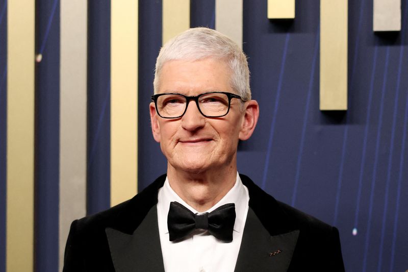 FILE PHOTO: Apple CEO Tim Cook poses on the red carpet at the 77th Primetime Emmy Awards in Los Angeles, California, U.S., September 14, 2025. REUTERS/David Swanson/File Photo