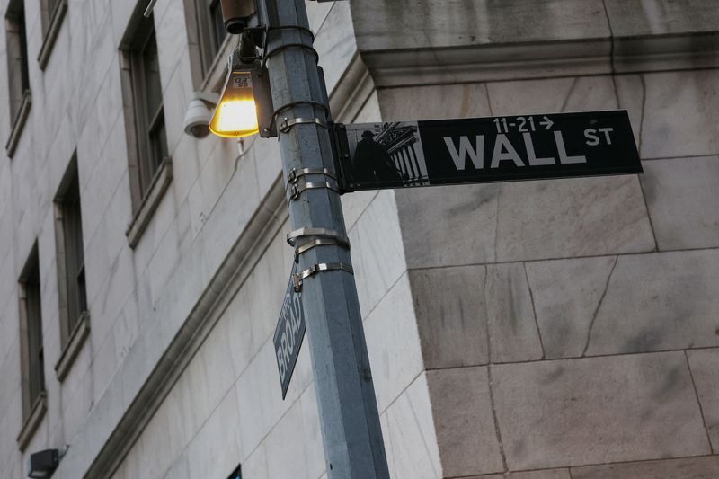 The Wall street sign hangs outside the New York Stock Exchange (NYSE) building on Tuesday following Monday’s broad sell off in New York City, U.S., March 11, 2025. REUTERS/Shannon Stapleton