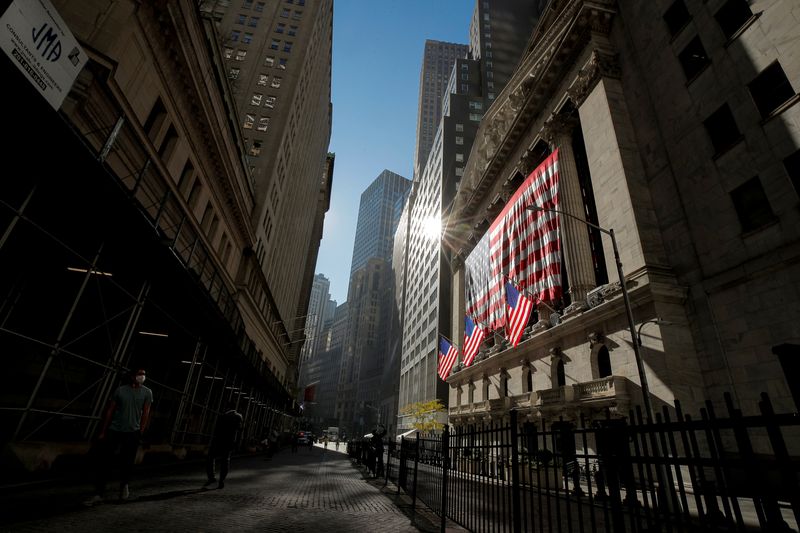 The U.S. flag covers the front facade of the New York Stock Exchange (NYSE) in New York City, New York, U.S., November 9, 2020. REUTERS/Brendan McDermid