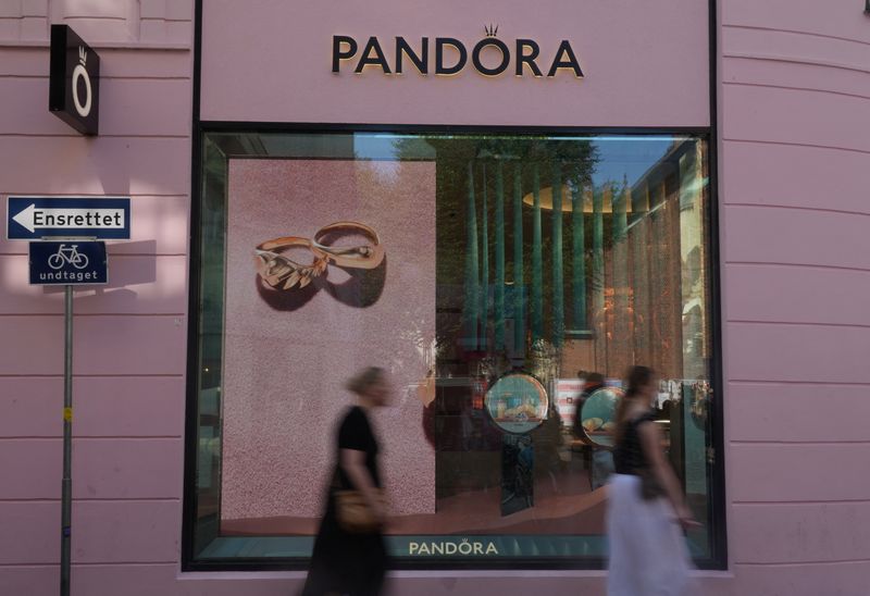 Pedestrians walks past a branch of the Danish jewellery maker Pandora in central Copenhagen, Denmark, August 13, 2025. REUTERS/ Tom Little