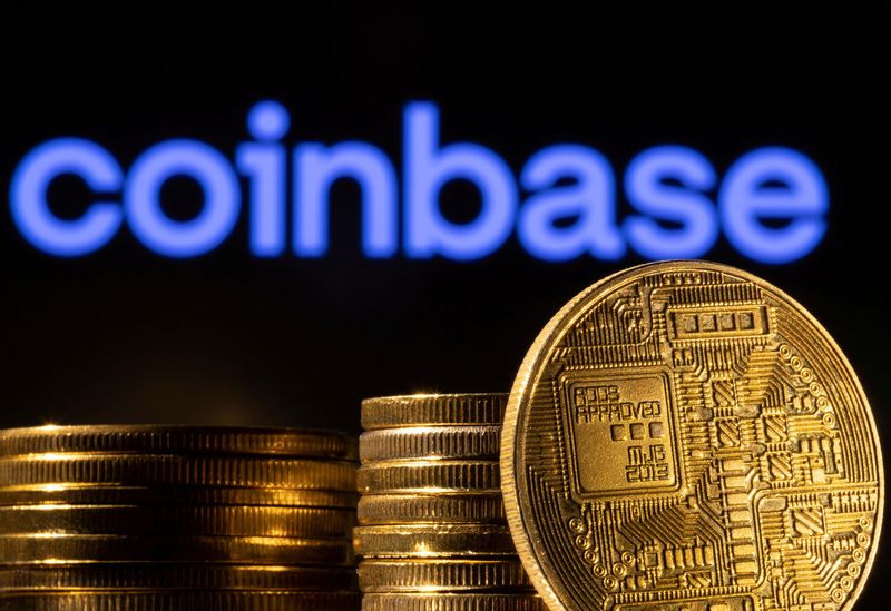 FILE PHOTO: A representation of the cryptocurrency is seen in front of Coinbase logo in this illustration taken, March 4, 2022. REUTERS/Dado Ruvic/Illustration/File Photo
