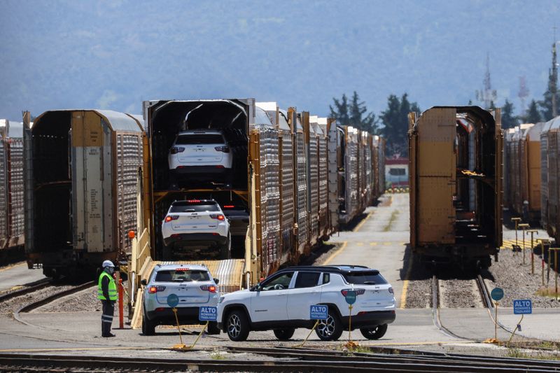 FILE PHOTO: Vehicles are loaded onto a train car at the Kansas City Southern de Mexico rail yard in Santa Ana Tlapaltitlan, Mexico, July 29, 2025 REUTERS/Raquel Cunha/File Photo