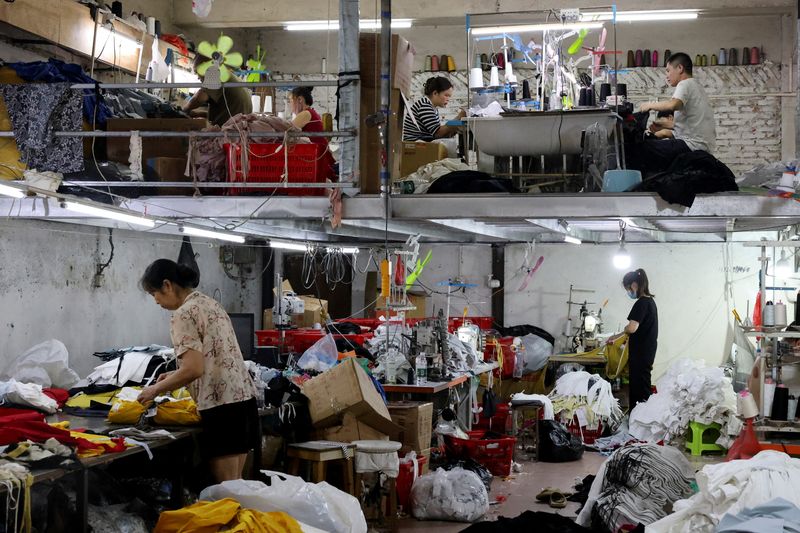 People work in a textile factory in Panyu district, Guangzhou, Guangdong province, China May 10, 2025. REUTERS/Go Nakamura