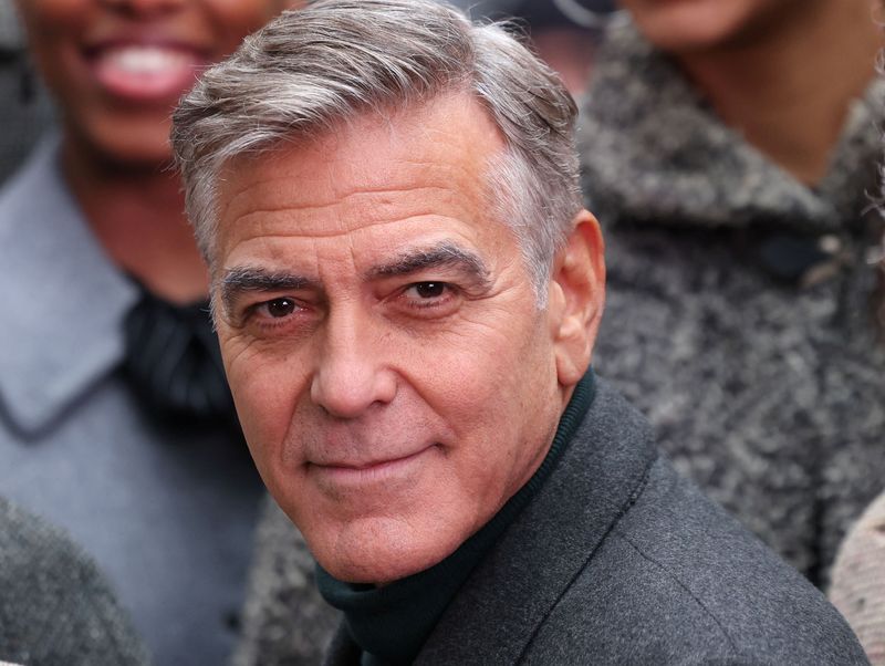 George Clooney poses with cast members of "Goodnight and Goodluck" outside the Winter Garden Theater, in New York City, U.S., February 6, 2025.  REUTERS/Caitlin Ochs