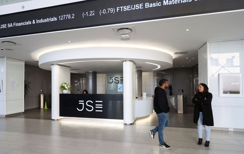 People chat next to the reception of the Johannesburg Stock Exchange (JSE), in Sandton, South Africa, August 1, 2025. REUTERS/Siphiwe Sibeko