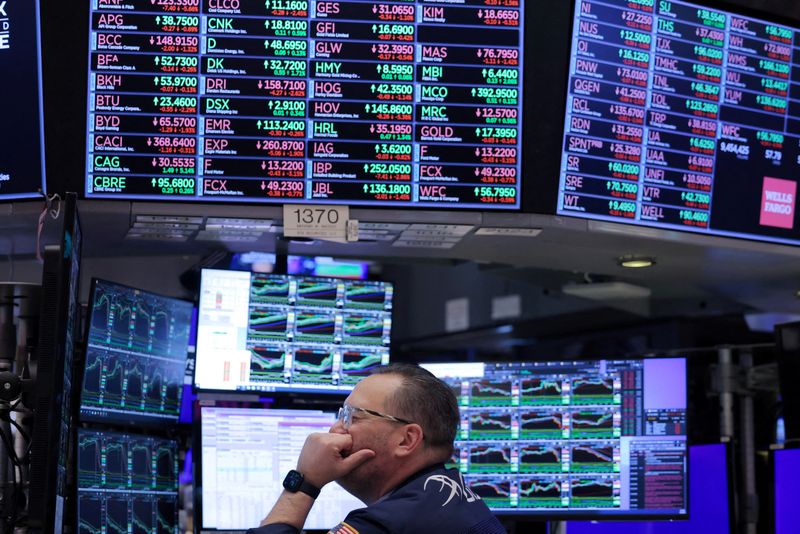 FILE PHOTO: A trader works on the trading floor at the New York Stock Exchange (NYSE) in New York City, U.S., April 4, 2024. REUTERS/Andrew Kelly/File Photo