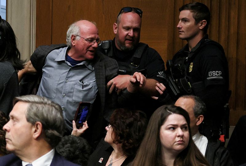 FILE PHOTO: Ben Cohen, co-founder of ice cream company Ben & Jerry’s, is removed by U.S. Capitol Police, as U.S. Health and Human Services (HHS) Secretary Robert F. Kennedy Jr. (Not Pictured) testifies before a Senate Health, Education, Labor & Pensions Committee hearing on the Department of Health and Human Services budget, on Capitol Hill in Washington, D.C., U.S., May 14, 2025. REUTERS/Leah Millis/File Photo