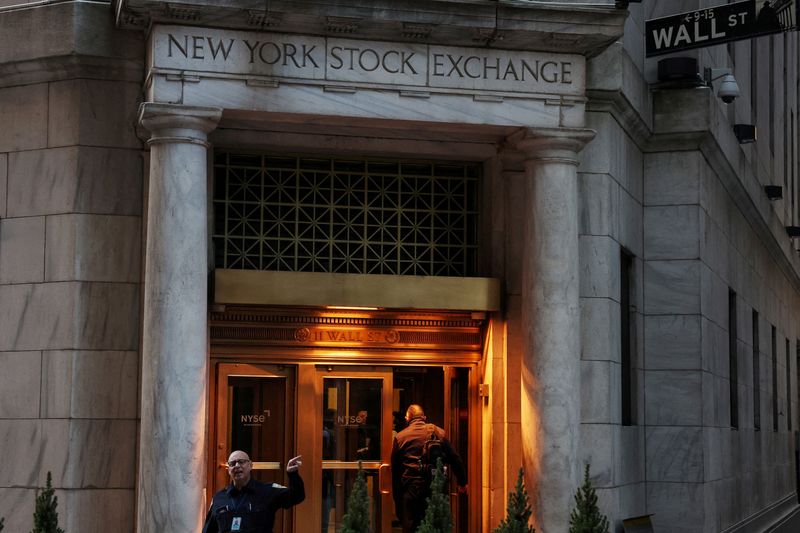 FILE PHOTO: A man walks into the New York Stock Exchange (NYSE) building in New York City, U.S., March 11, 2025. REUTERS/Shannon Stapleton/File Photo