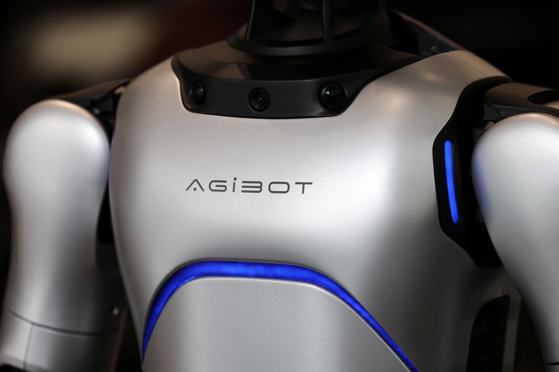 An AgiBot humanoid robot stands at a China Yongda Automobiles Services Holdings Ltd. car dealership, in Shanghai, China, April 8, 2025.  REUTERS/Go Nakamura