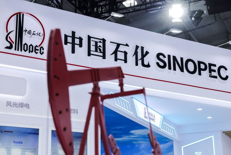 A model of oil pump jack stands next to a logo of China Petroleum & Chemical Corporation, or Sinopec, at the company's booth at the China International Fair for Trade in Services (CIFTIS) in Beijing, China, September 11, 2025. REUTERS/Maxim Shemetov