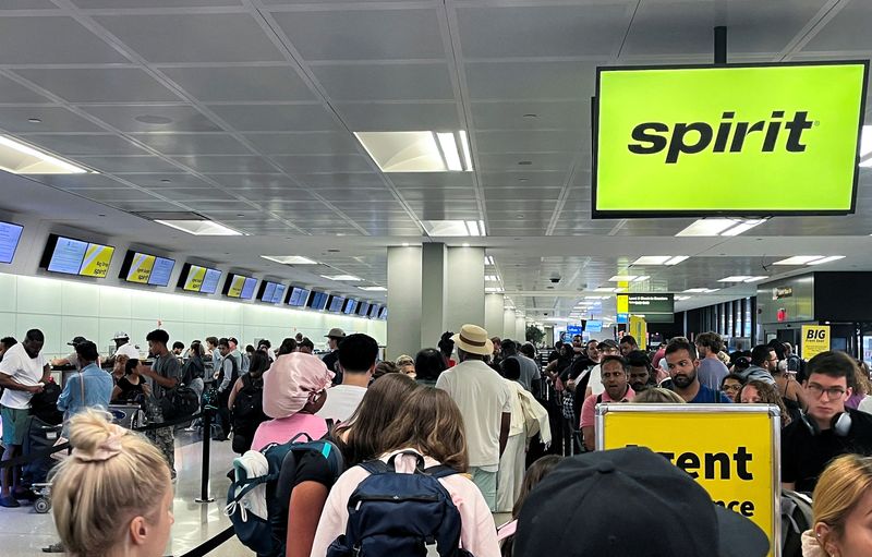 FILE PHOTO: Travelers stand in line at the check-in counter at Spirit Airlines at Newark Liberty International Airport, in Newark, New Jersey, U.S., June 30, 2025. REUTERS/Sami Marshak/File Photo