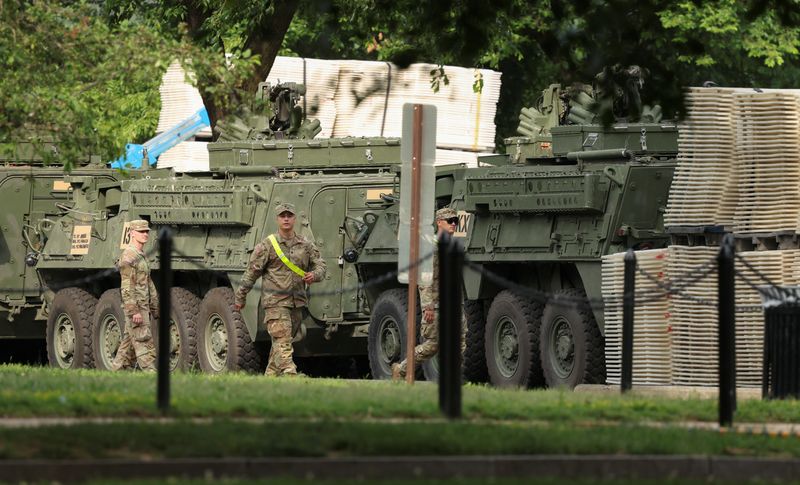 Soldiers walk past Stryker combat vehicles parked in West Potomac Park ahead of the upcoming U.S. Army 250th anniversary celebration parade in Washington, D.C., U.S., June 10, 2025.  REUTERS/Kevin Lamarque
