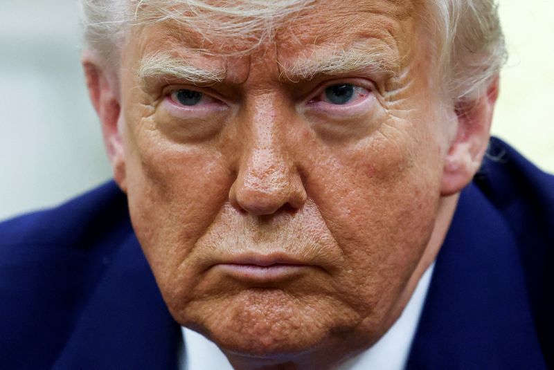 FILE PHOTO: U.S. President Donald Trump looks on as he meets South African President Cyril Ramaphosa in the Oval Office of the White House in Washington, D.C., U.S., May 21, 2025. REUTERS/Kevin Lamarque/File Photo