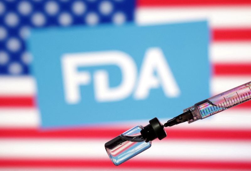 FILE PHOTO: A U.S. flag, a U.S. Food and Drug Administration (FDA) logo, a syringe and a vial are seen in this illustration taken May 13, 2025. REUTERS/Dado Ruvic/Illustration/File Photo