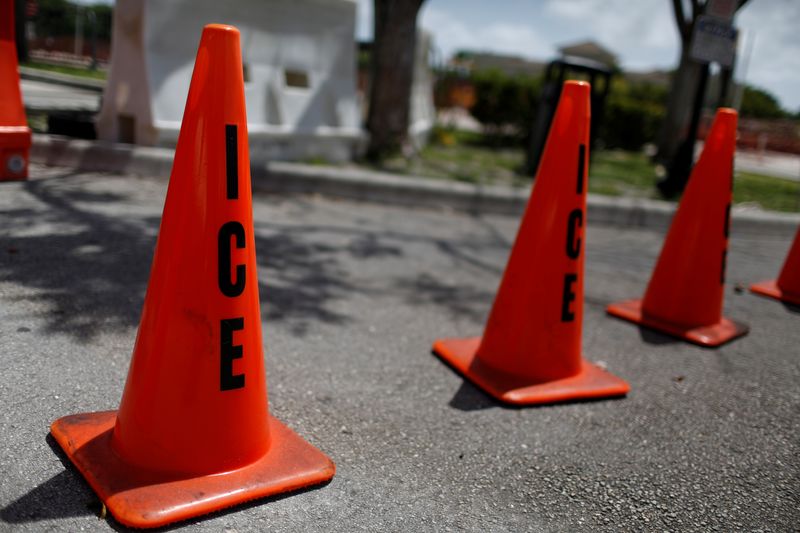 FILE PHOTO: Orange traffic cones with the word "ICE" are seen at Immigration and Customs Enforcement (ICE) facilities in Miramar, near Miami, Florida, U.S. July 14, 2019. REUTERS/Marco Bello/File Photo