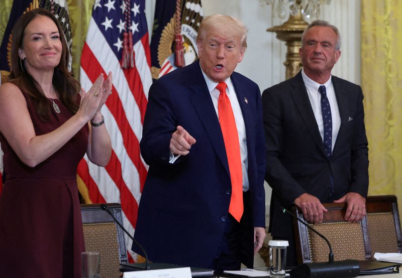 FILE PHOTO: U.S. President Donald Trump, Health and Human Services (HHS) Secretary Robert F. Kennedy Jr.,  Secretary of Agriculture Brooke Rollins attend a Make America Healthy Again (MAHA) Commission event, in the East Room of the White House in Washington, D.C., U.S., May 22, 2025. REUTERS/Evelyn Hockstein/File Photo/File Photo